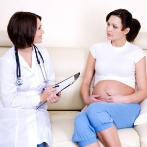 doctor communicates with pregnant woman  - indoors